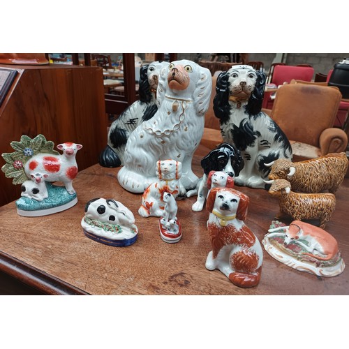 411 - A  collection of porcelain to include wally dogs, highland cows, rabbit, cats etc