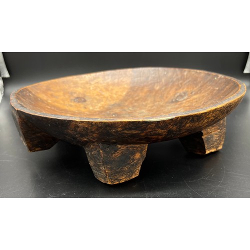 34 - Carved Tribal bowl. Supported on block feet. [29cm in diameter]