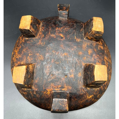 34 - Carved Tribal bowl. Supported on block feet. [29cm in diameter]