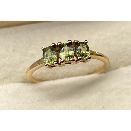 44 - 10ct yellow gold ladies ring set with three green emerald stones. [Ring size P] [1.83Grams]