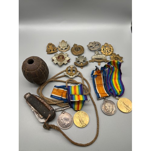 532 - A Selection of military items to include de-conditioned grenade, Two pairs of WWI medals belonging t... 