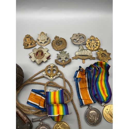 532 - A Selection of military items to include de-conditioned grenade, Two pairs of WWI medals belonging t... 