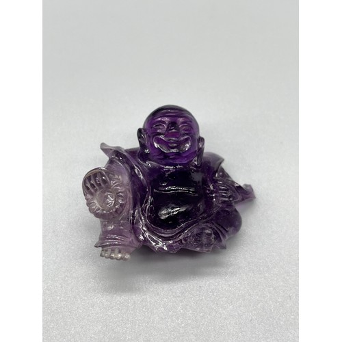 541 - Antique Chinese hand carved sculpture of a sitting buddha- carved from an amethyst stone. [4cm high]