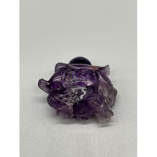 541 - Antique Chinese hand carved sculpture of a sitting buddha- carved from an amethyst stone. [4cm high]