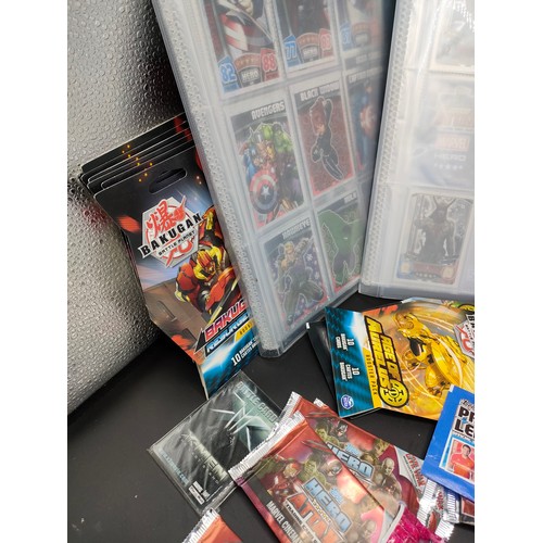 105 - Five albums of Marvel Avengers collectors cards and a large selection of sealed packs of collectors ... 