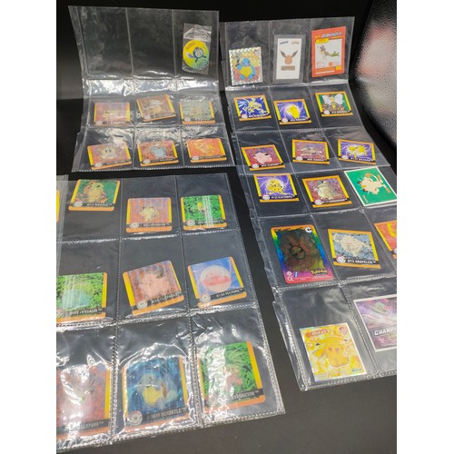 112 - Small album of various Pokémon cards and five sleeves of Pokémon Artbox stickers