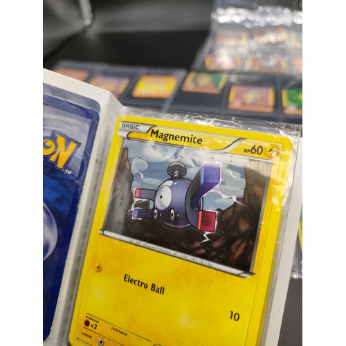 112 - Small album of various Pokémon cards and five sleeves of Pokémon Artbox stickers