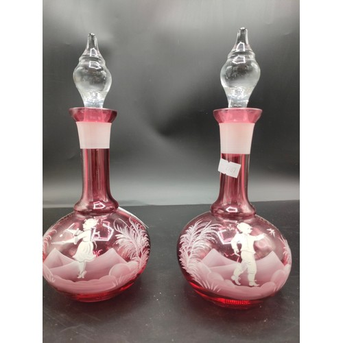 148 - Pair of Victorian Ruby glass Mary Gregory decanters and stoppers