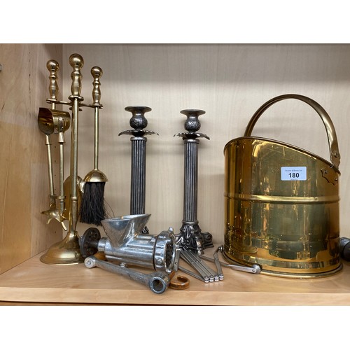 180 - A Shelf of collectables to include two metal Corinthian column candle sticks, Brass helmet coal scut... 