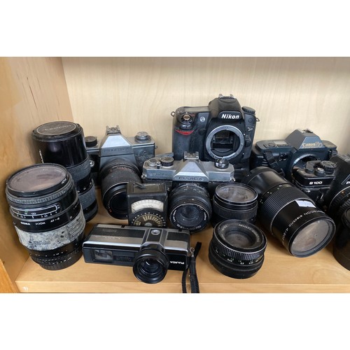 181 - A Shelf of cameras and lenses to include Nikon D80, Canon T70, Praktica B100 camera bodies.