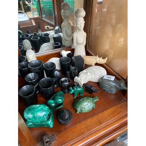 189 - A Collection of hardstone and malachite carvings. Includes African busts, Hippo, Rhino and eggs.