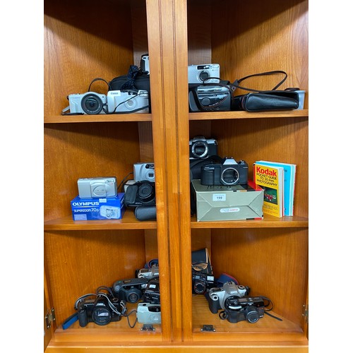 199 - Three shelves of various cameras includes Canon t50, Canon EOS 300, Rebel X, XL Zoom and many others... 