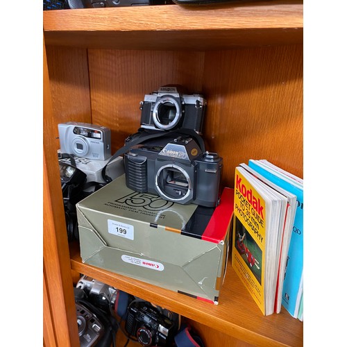 199 - Three shelves of various cameras includes Canon t50, Canon EOS 300, Rebel X, XL Zoom and many others... 