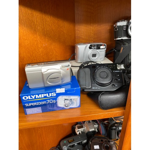 199 - Three shelves of various cameras includes Canon t50, Canon EOS 300, Rebel X, XL Zoom and many others... 