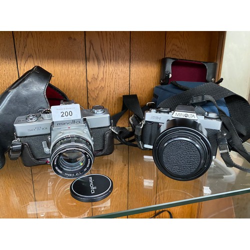 200 - Shelf of cameras to include Minolta 7s, Topcon RM300, Minolta SRT101 AND XG-1.