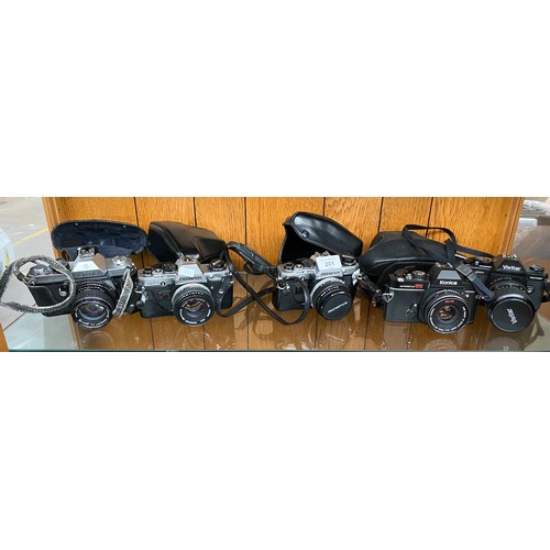 201 - A Shelf of cameras to include Pentax K2, Olympus OM10, Konica Autoreflex TC and Vivitar V3800N.