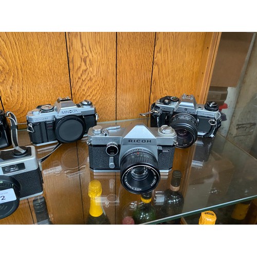 202 - A Shelf of cameras to include Ricoh XR-2, Fujica ST605N, Canon EOS 1000, Minolta X-500, Ricoh and Pr... 