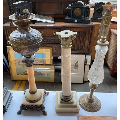 217 - Three antique paraffin lamp bases. Includes onyx and brass Corinthian column bases and brass and gla... 