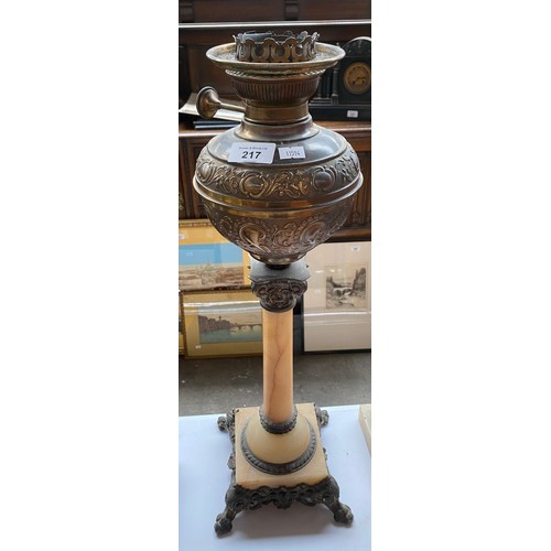 217 - Three antique paraffin lamp bases. Includes onyx and brass Corinthian column bases and brass and gla... 