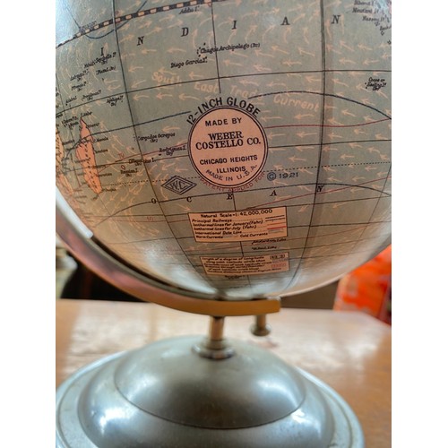 221 - 1920's desk top globe fitted with a metal plane model. 12inch globe made by Weber Costello Co.