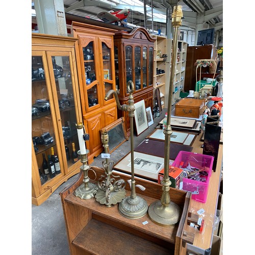 229 - Four antique brass table lamps to include two rise and fall movement lamps.