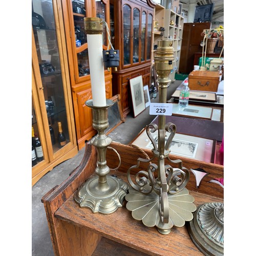 229 - Four antique brass table lamps to include two rise and fall movement lamps.