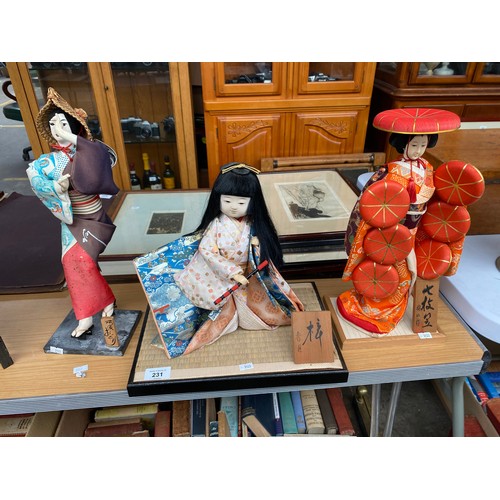 231 - A Collection of three Oriental themed dolls wearing decorative gowns with signed blocks. Together wi... 