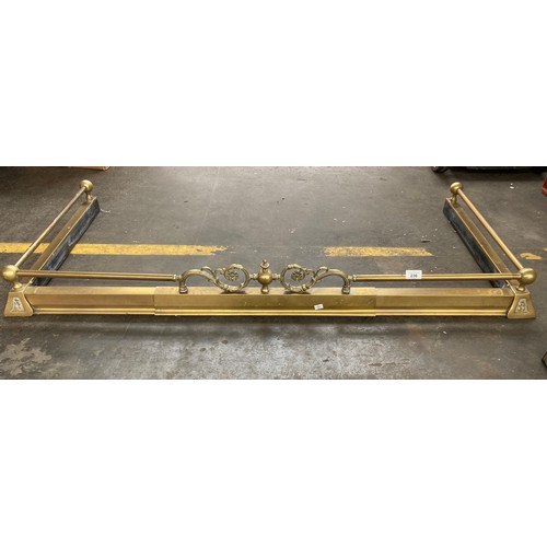 236 - Antique brass fire fender. Together with a chrome designed fire fender