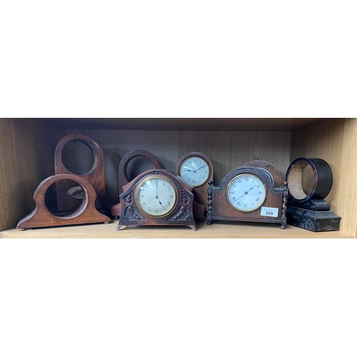 289 - A Shelf of antique wooden clock cases and mantel clocks.