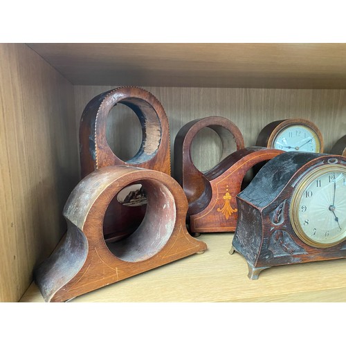 289 - A Shelf of antique wooden clock cases and mantel clocks.