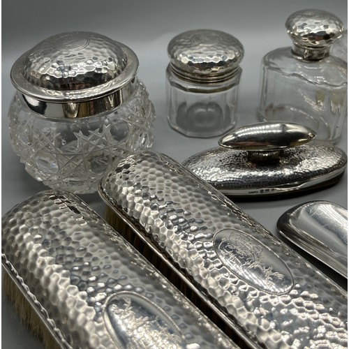 30 - A Collection of London and Birmingham hammered silver dressing table items, Includes Drew & Sons sho... 