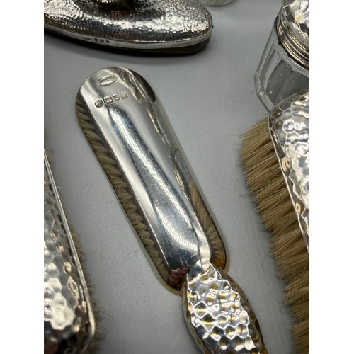 30 - A Collection of London and Birmingham hammered silver dressing table items, Includes Drew & Sons sho... 