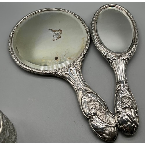 29 - Four Silver ornate cherub design dressing table items. Two hand mirrors, button hook and lidded pres... 