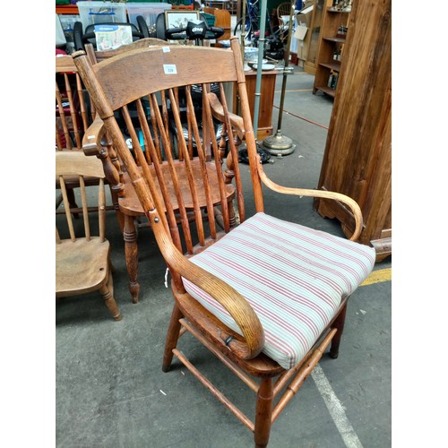 339 - Antique oak smokers arm chair, Curved back with spindle reed supports & bent wood oak arm rests.