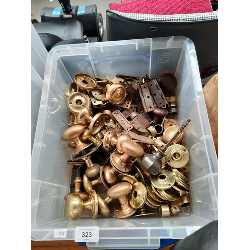 323 - A Box containing a large quantity of fixtures and fittings, includes mostly brass door handles, hing... 