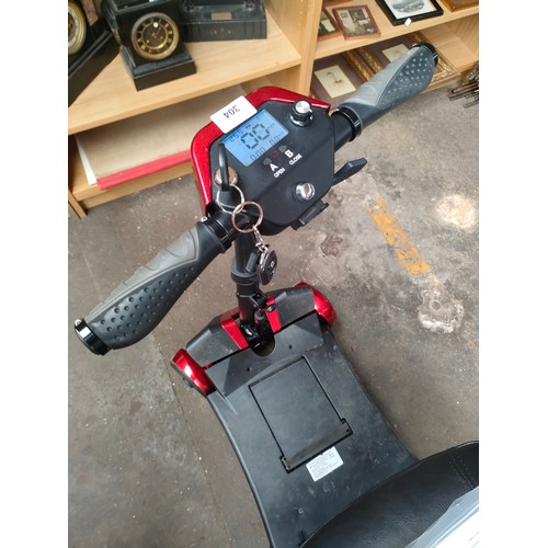 304 - Disability folding scooter, comes with key, manuals  and charger. In a working condition.