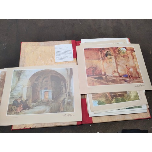 298 - Portfolio containing various art prints and artworks to include watercolour depicting loch signed T.... 