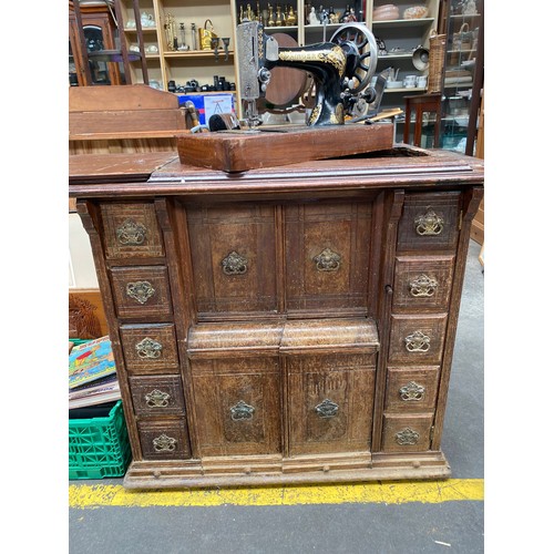 352 - Antique sewing cabinet with singer sewing machine