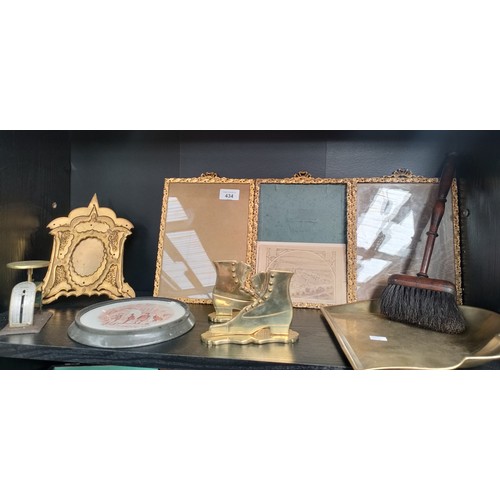 434 - Shelf of antique gilt framing to include brass eastern themed frames, brass postal scales, brass boo... 