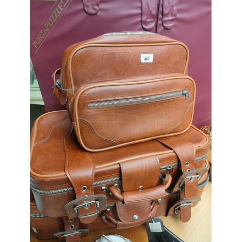 457 - Two vintage brown leather suitcases and matching carry travel bag.