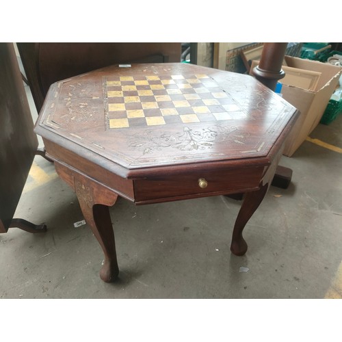 Octagonal brass inlaid chess table.