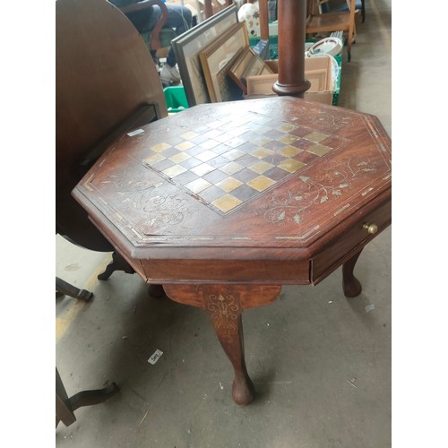 Octagonal brass inlaid chess table.