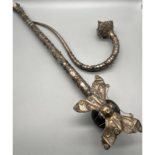 92 - A Lot of two antique foreign white metal and filigree worked smoking/ opium pipes. One pulls open to... 