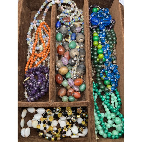 82 - A Tray of vintage necklaces. to include Malachite, Raw Amethyst bead necklace, Coral necklace and va... 