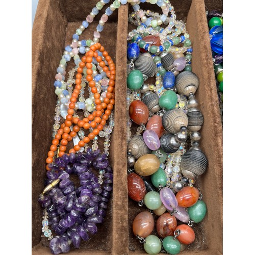 82 - A Tray of vintage necklaces. to include Malachite, Raw Amethyst bead necklace, Coral necklace and va... 