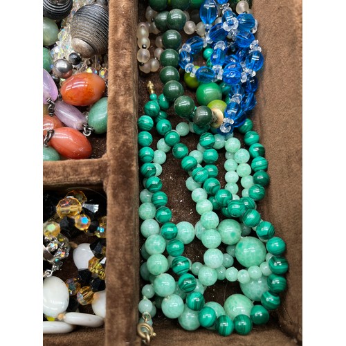 82 - A Tray of vintage necklaces. to include Malachite, Raw Amethyst bead necklace, Coral necklace and va... 