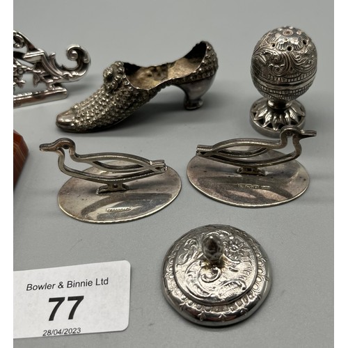 77 - A Collection of silver marked items to include agate paperweight, duck shaped card holders, pin cush... 