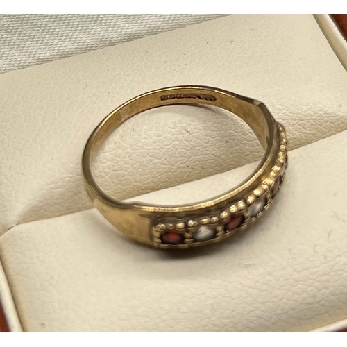 69 - Ladies 9ct yellow gold ring set with garnet and clear quartz stones. [Ring size M] [2Grams]