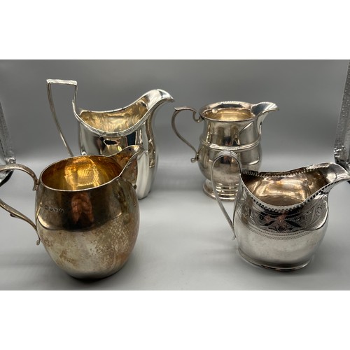 47 - Four Silver cream jugs. Small Georgian London jug with fancy trim. Jubilee marked London silver jug,... 