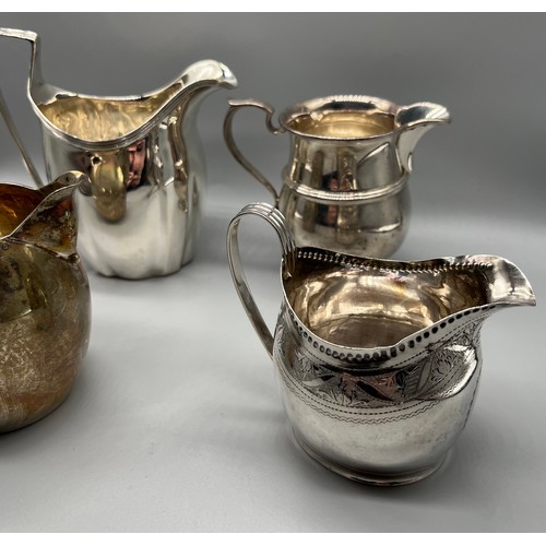 47 - Four Silver cream jugs. Small Georgian London jug with fancy trim. Jubilee marked London silver jug,... 